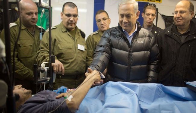 Israeli regime's Prime Minister Benjamin Netanyahu visits injured anti-Syria insurgents in an Israeli field hospital