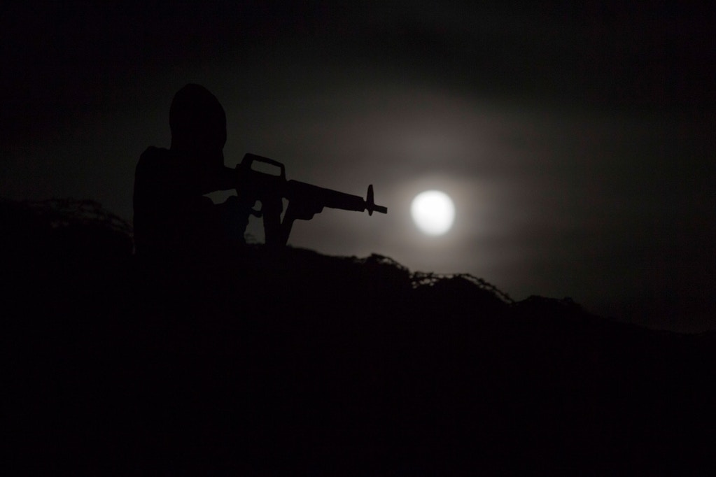 A metal placard in the shape of an Israeli soldier stands on an old bunker as the moon rises over Syria, as seen from the Israeli-occupied Golan Heights, on Monday, Nov. 14, 2016. Photo: Ariel Schalit/AP